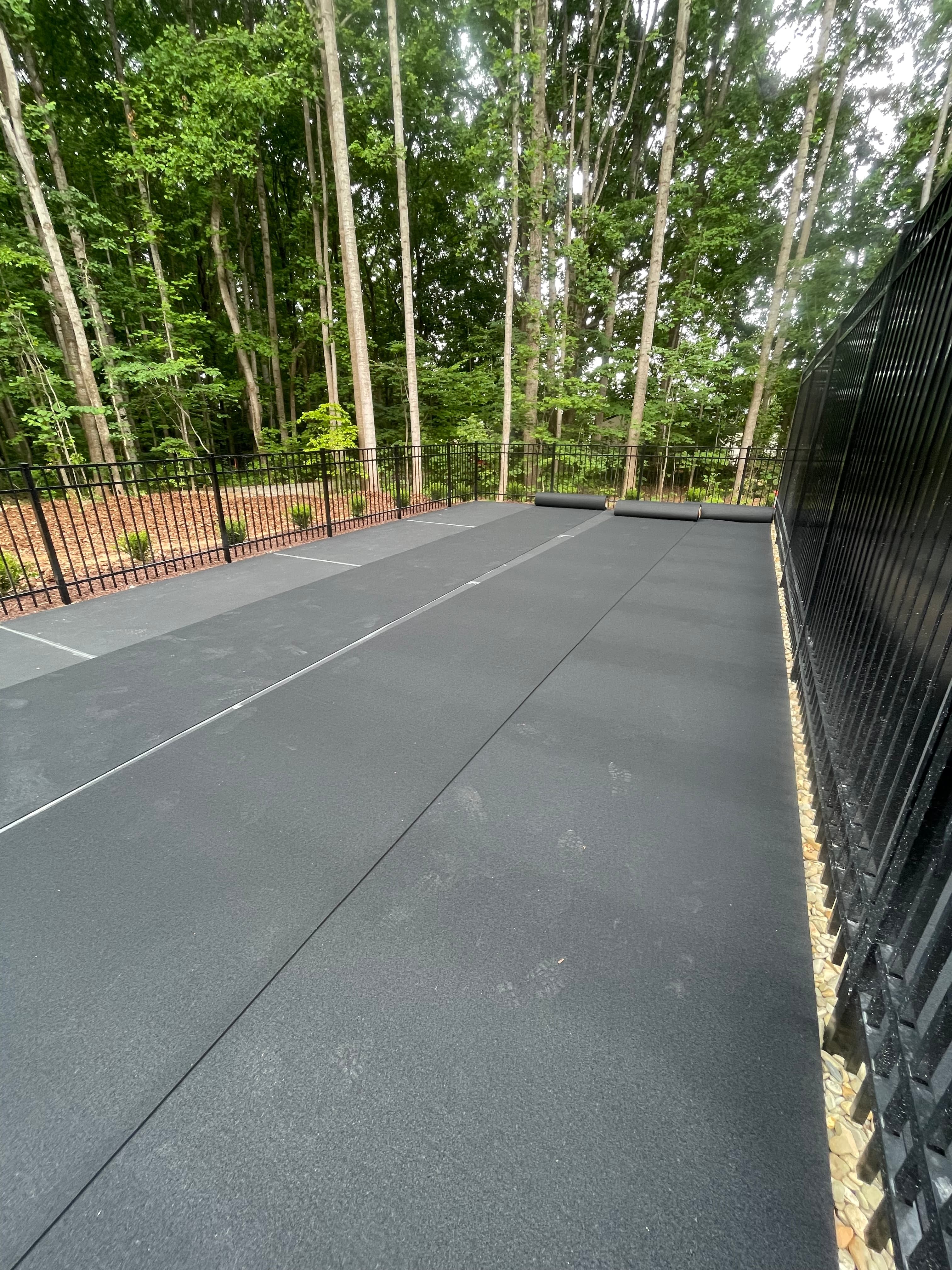 Rubber mat cushioned court installation in progress